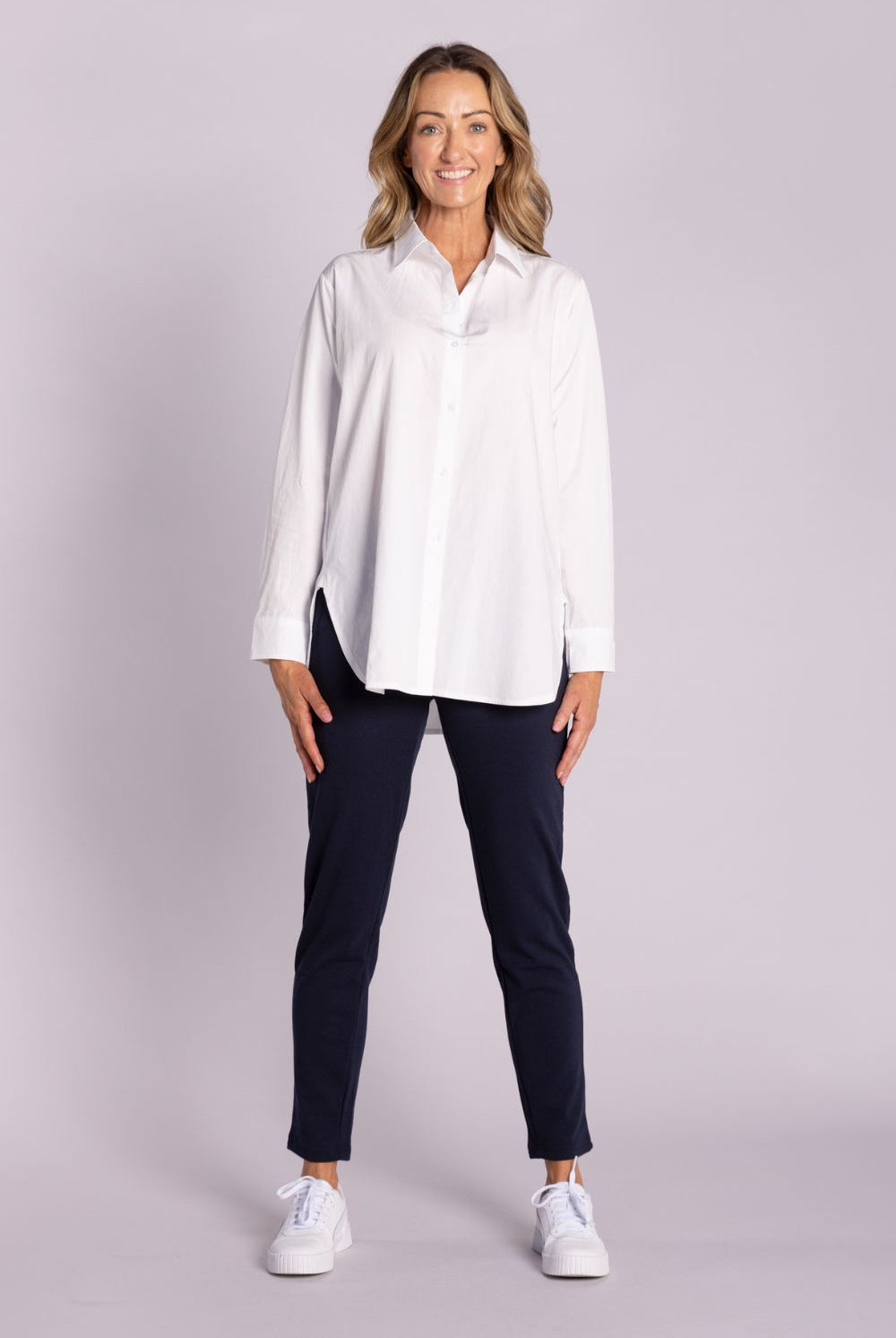 White Chloe Shirt – breathable cotton, viscose & tencel blend with side splits, rounded hemline, and button front. Shop now at Silvermaple Boutique.