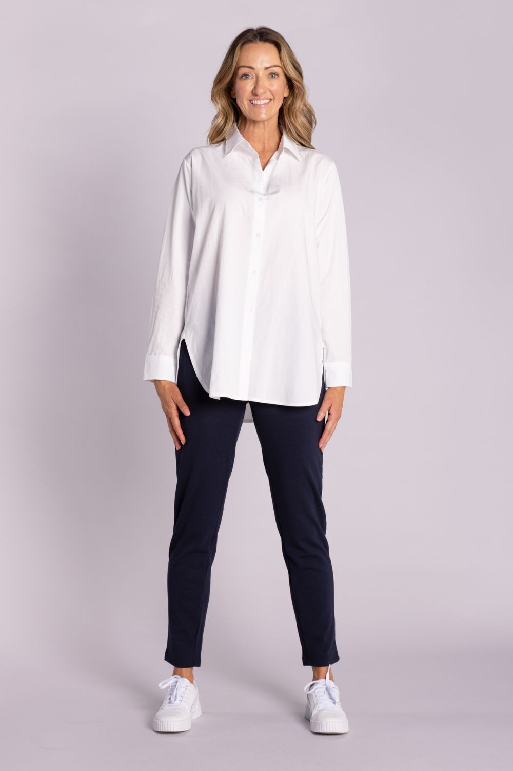 White Chloe Shirt – breathable cotton, viscose & tencel blend with side splits, rounded hemline, and button front. Shop now at Silvermaple Boutique.