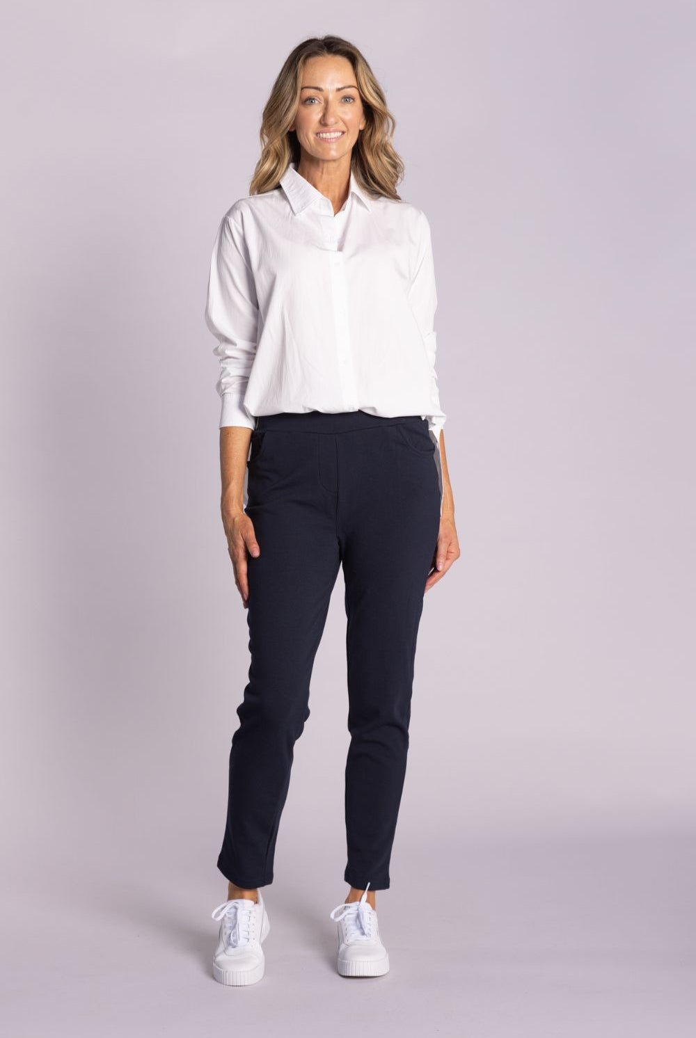 White Chloe Shirt – breathable cotton, viscose & tencel blend with side splits, rounded hemline, and button front. Shop now at Silvermaple Boutique.