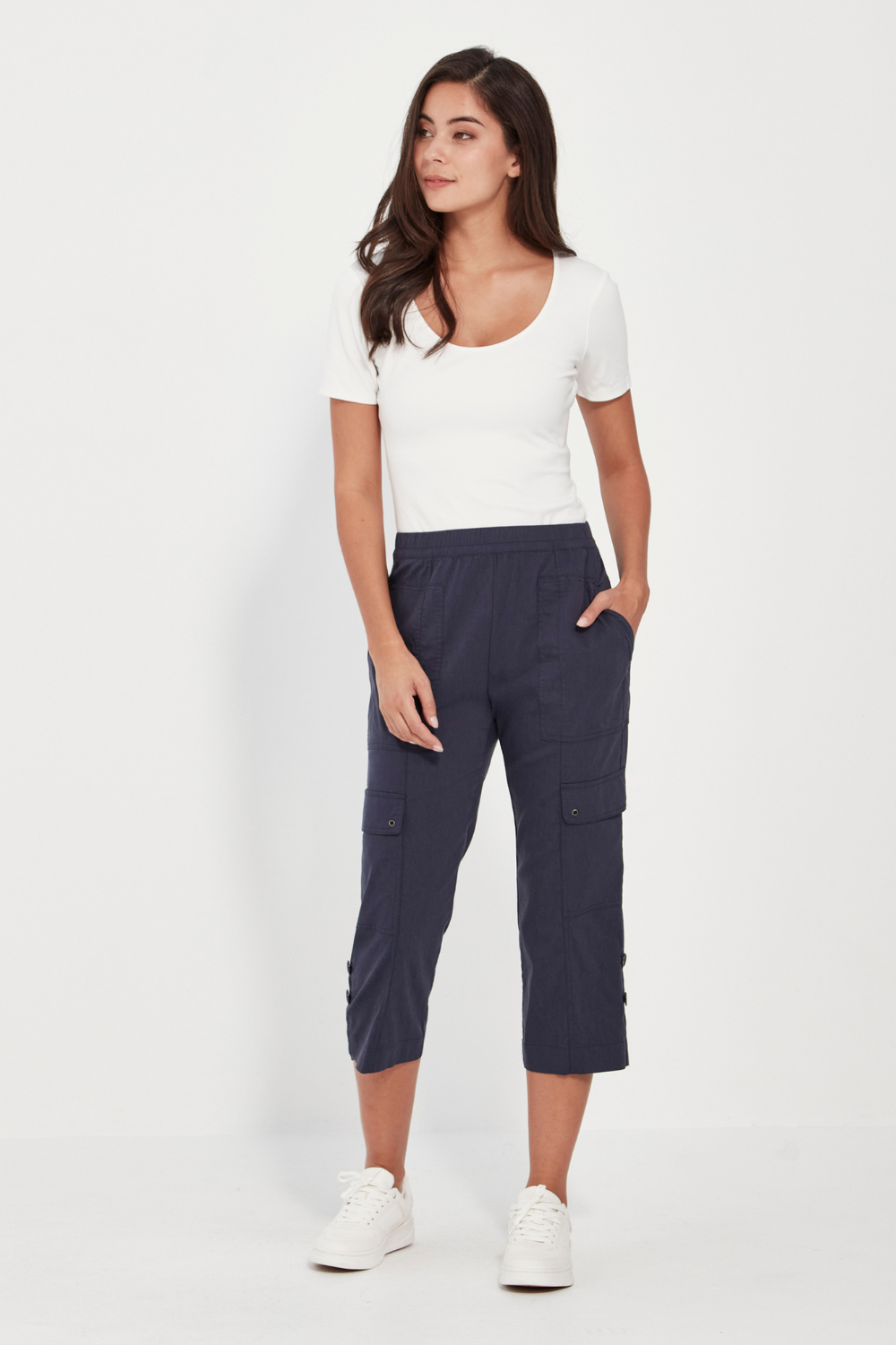 Woman wearing denim marle Verge Acrobat Cargo Short with a white top on a white background. Available online at Silvermaple Boutique.