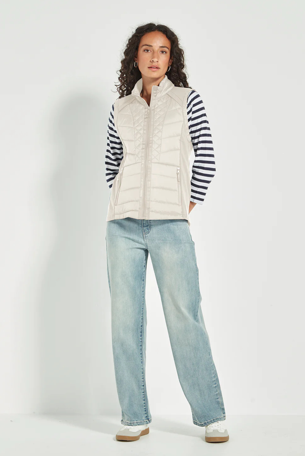 Woman wearing the Verge Idaho Cashew Vest with denim jeans, available online at Silvermaple Boutique.