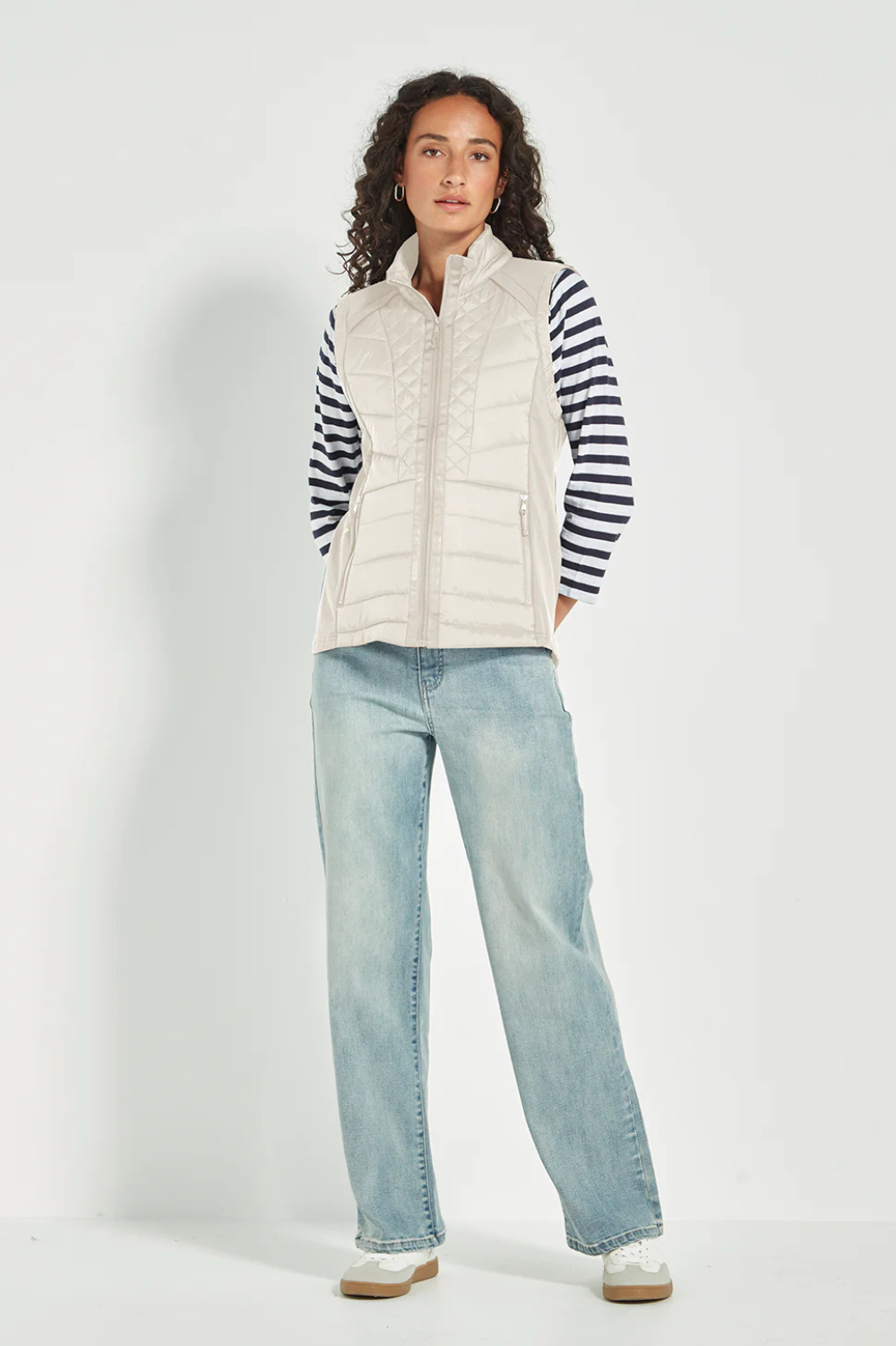 Woman wearing the Verge Idaho Cashew Vest with denim jeans, available online at Silvermaple Boutique.