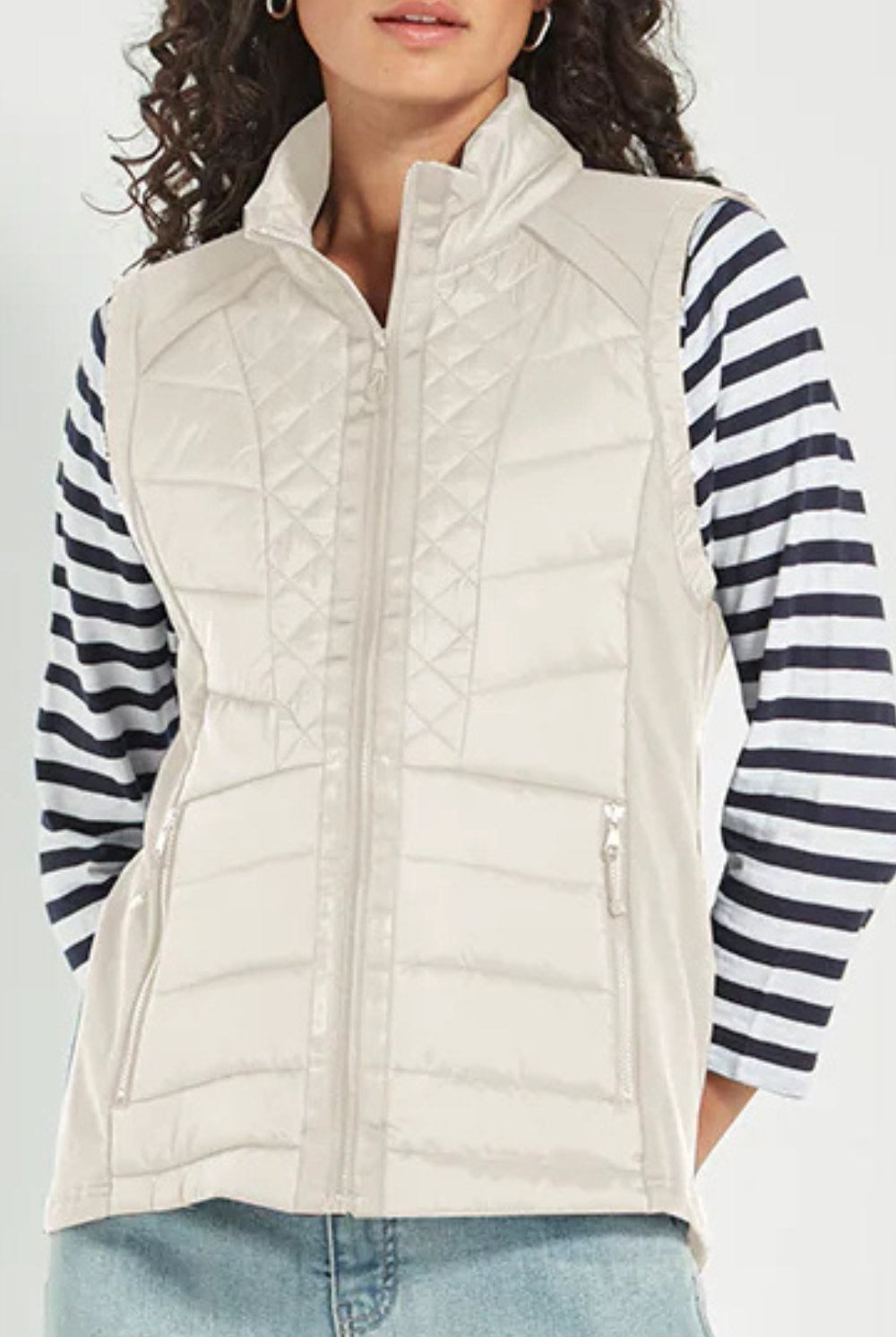 Woman wearing the Verge Idaho Cashew Vest with denim jeans, available online at Silvermaple Boutique.