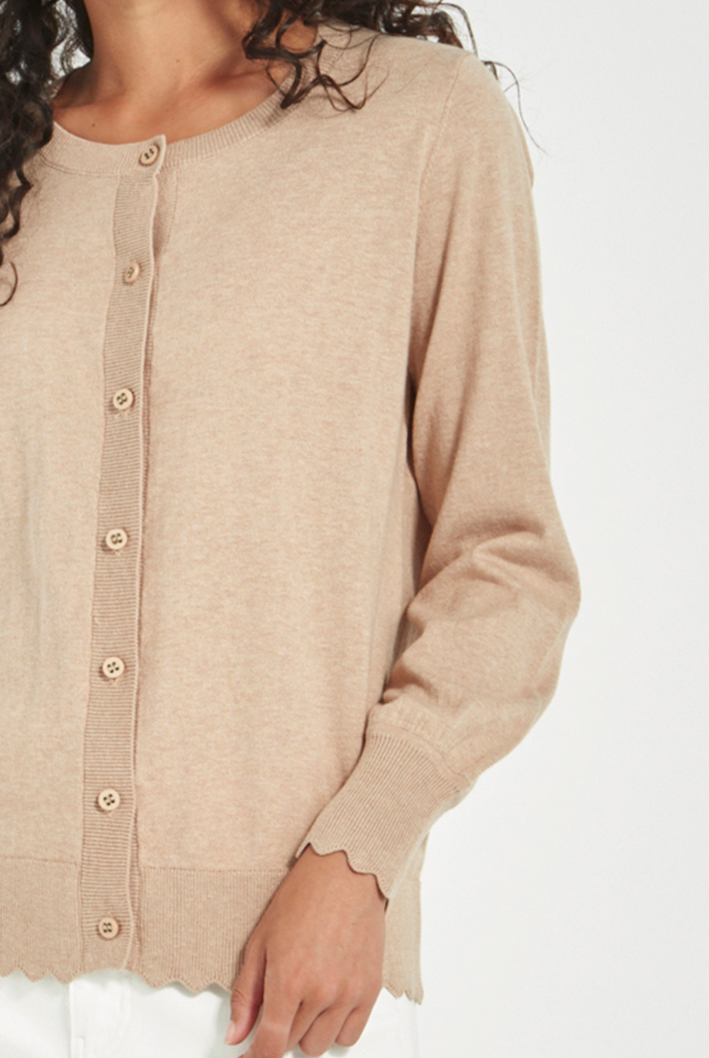 Woman wearing Verge Sass Cardi in Biscuit at Silvermaple Boutique with white pants. Shop Verge online now!