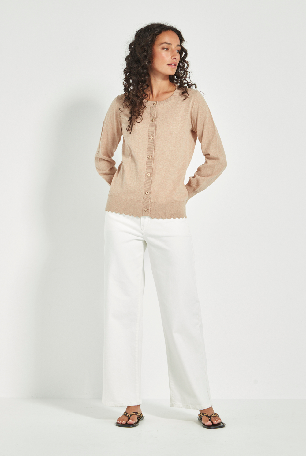 Woman wearing Verge Sass Cardi in Biscuit at Silvermaple Boutique with white pants. Shop Verge online now!