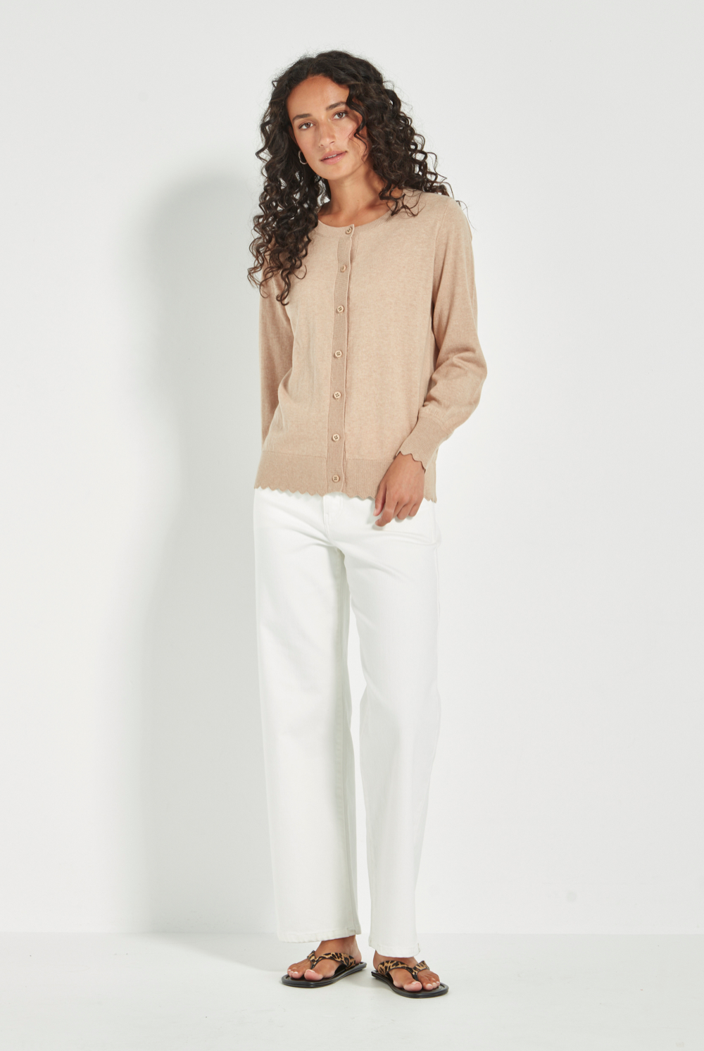Woman wearing Verge Sass Cardi in Biscuit at Silvermaple Boutique with white pants. Shop Verge online now!