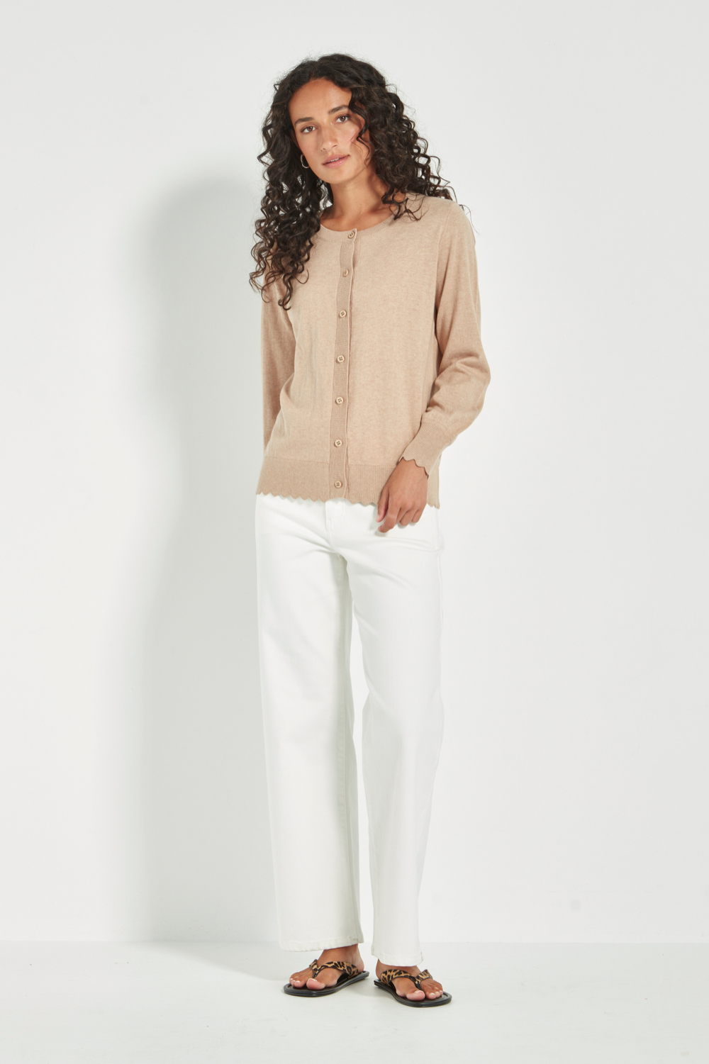 Woman wearing Verge Sass Cardi in Biscuit at Silvermaple Boutique with white pants. Shop Verge online now!