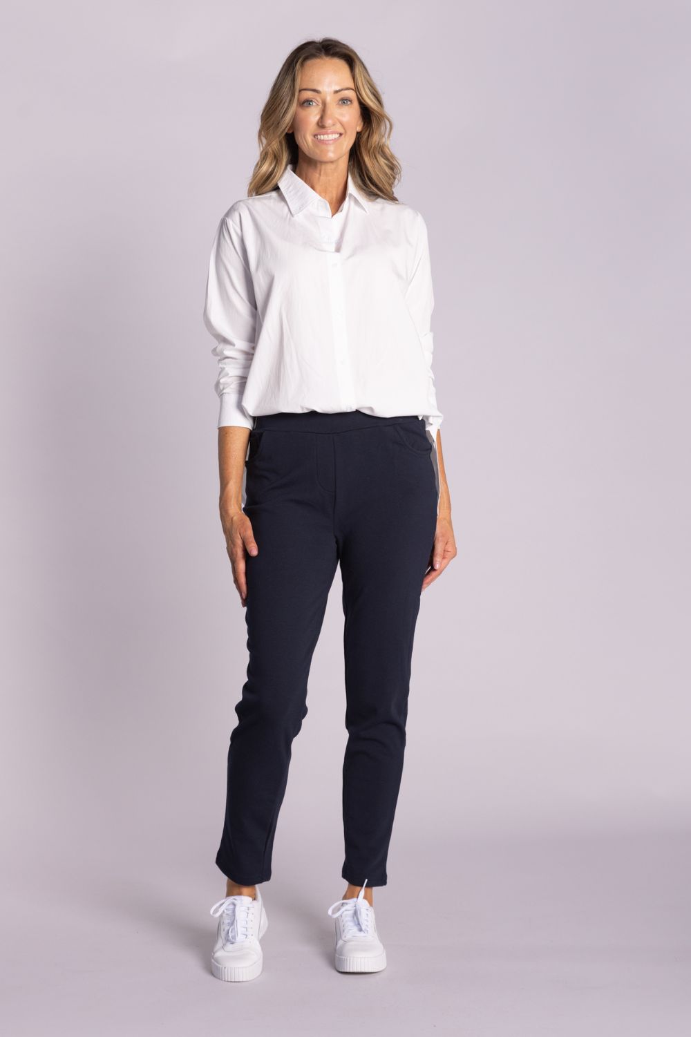 White Chloe Shirt – breathable cotton, viscose & tencel blend with side splits, rounded hemline, and button front. Shop now at Silvermaple Boutique.